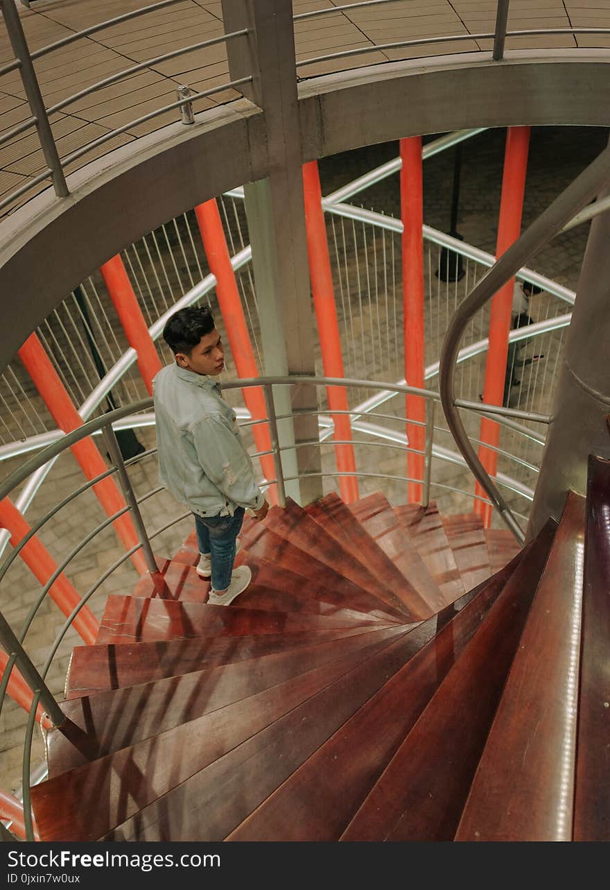 Man Wearing Gray Long-sleeved Top at the Staircase