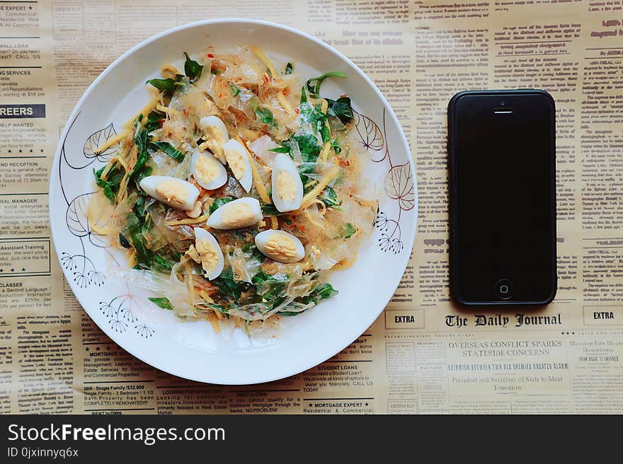 Black Iphone 5 Near Plate of Pasta Dish