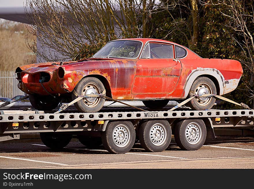 Red Coupe on Flatbed Trailer