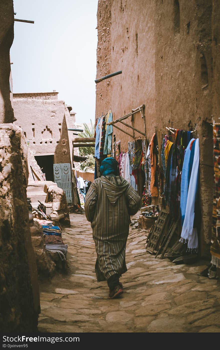 Photo of a Woman Passing Through the Alley