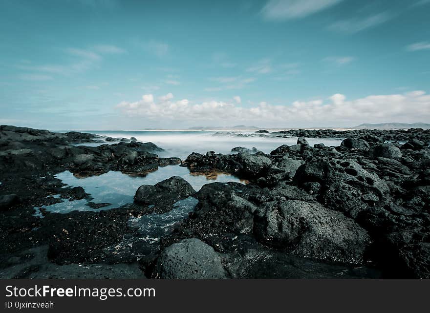 Seashore Under Blue Sky and White Clouds View