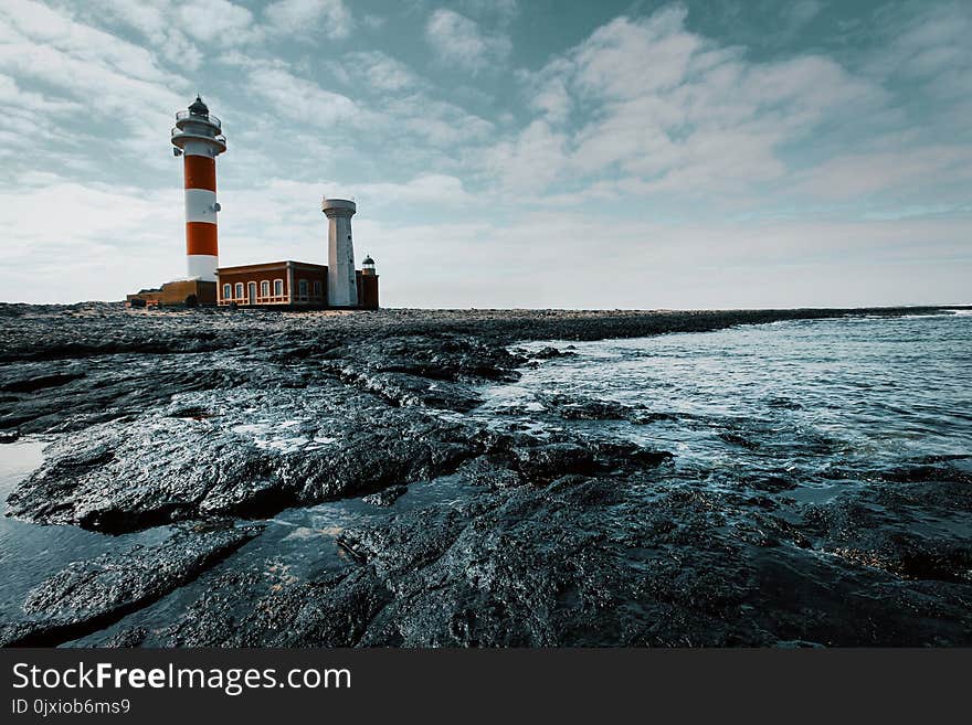 Red and White Lighthouse on Land