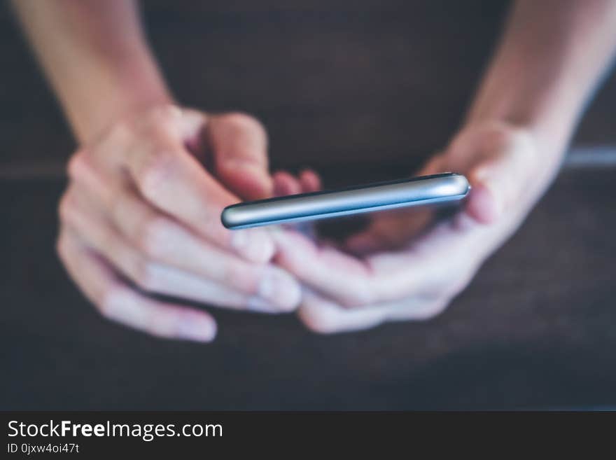 Hands holding phone macro - girl uses smartphone closeup -