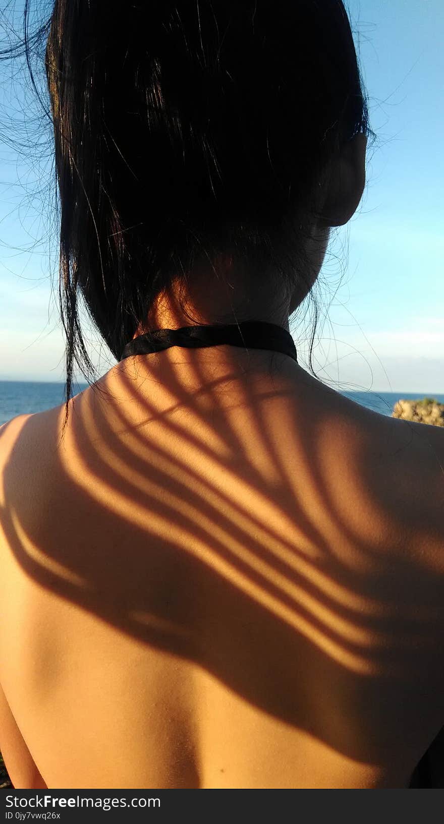 Woman Standing in Front of Body of Water