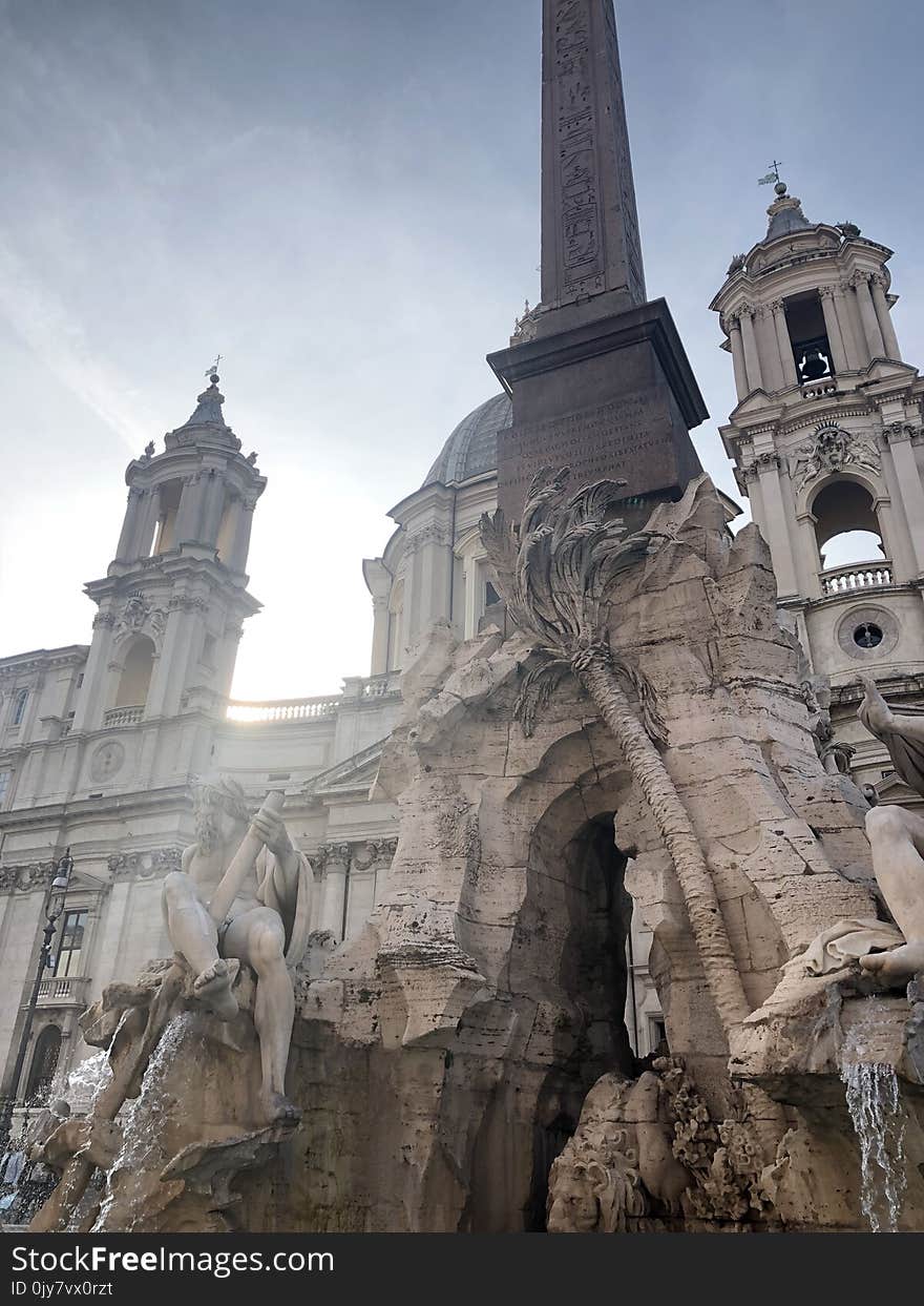 Low-angle Photo of Gray Concrete Building With Statues