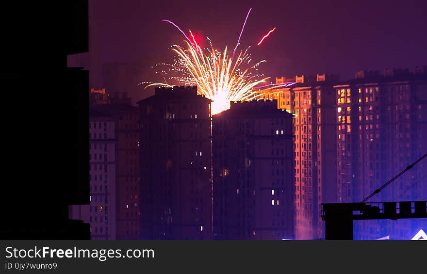 Fireworks Display Near High Rise Buildings during Nighttime