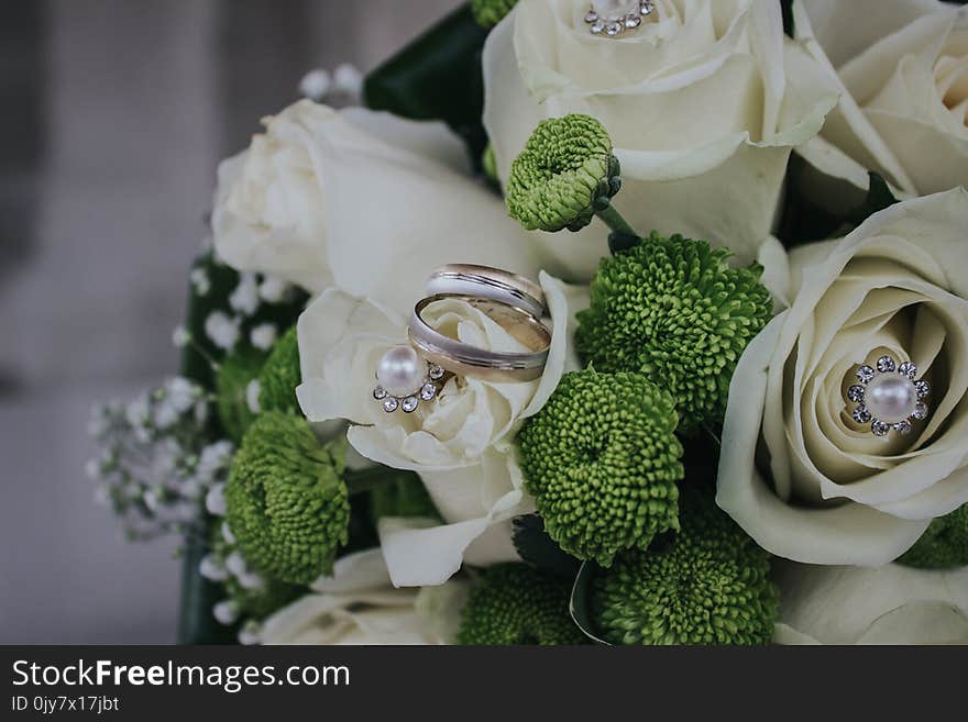 Red and Green Petaled Flowers Bouquet With Silver-colored Ring