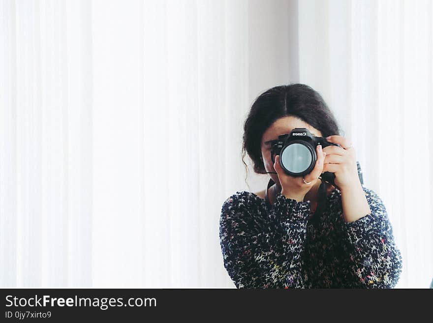 Woman in Black Long-sleeved Shirt Using Camera