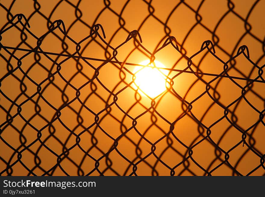 Sun over the Cyclone Fence