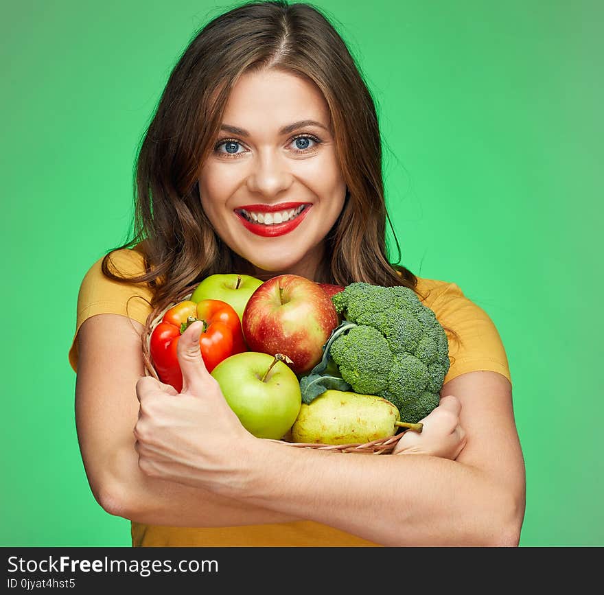 Young smiling woman holding straw basket with fruits and vegetables. green food.