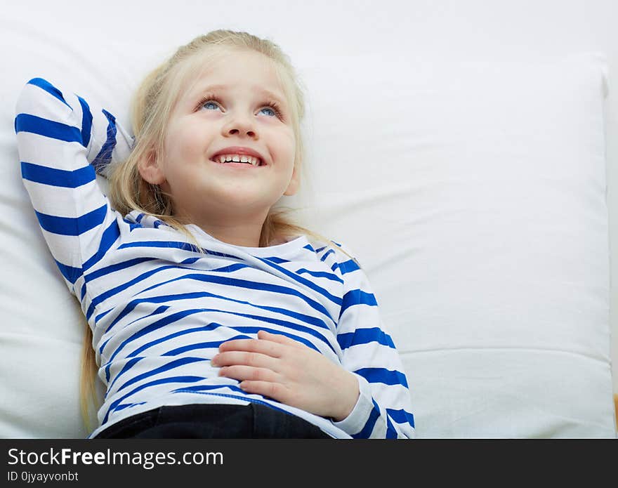 Little girl portrait . Kid lying and relax.