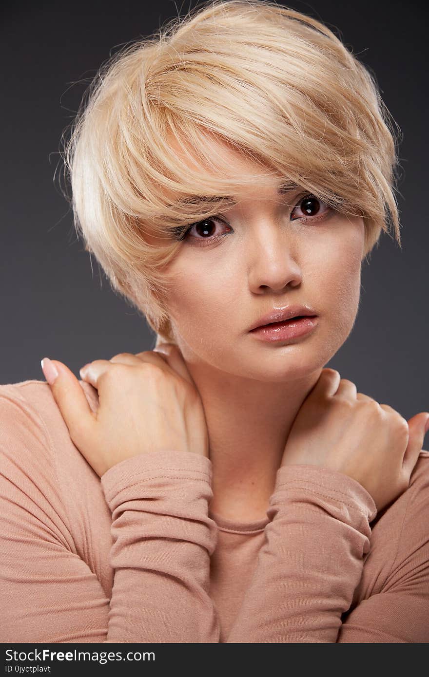 Portrait of beautiful woman with hands, isolated on gray. Fashion Makeup. Portrait of beautiful woman with hands, isolated on gray. Fashion Makeup