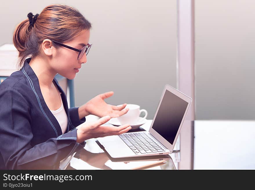 Asian office woman surprise or amazing mood , laptop in office, business woman working in office with surprise mood, woman looking screen of laptop and hand up
