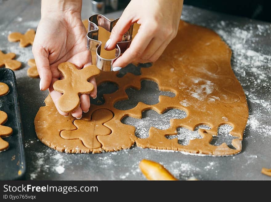 Female hands making festive Christmas gingerbread cookies