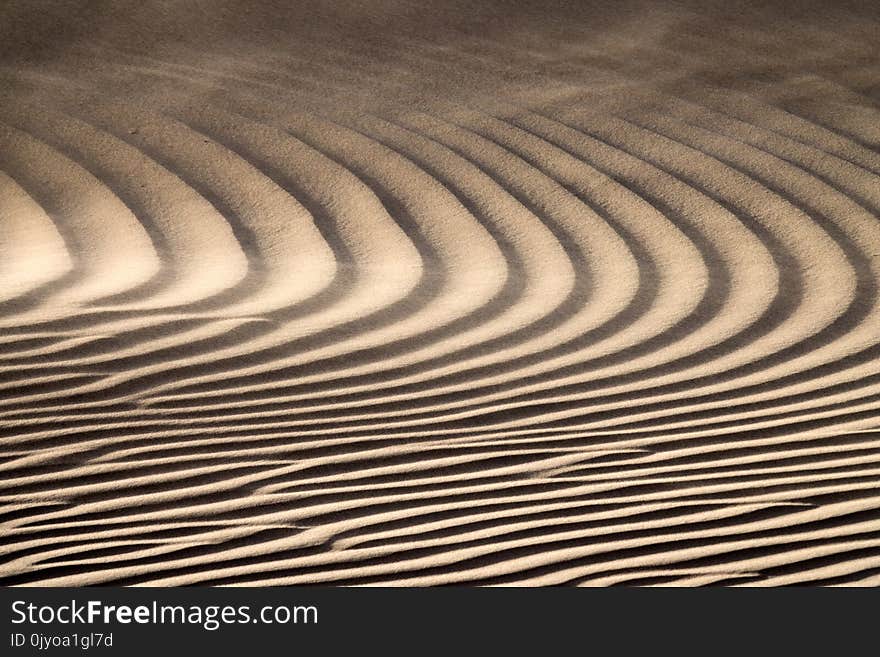 Wind blowing over sand dunes