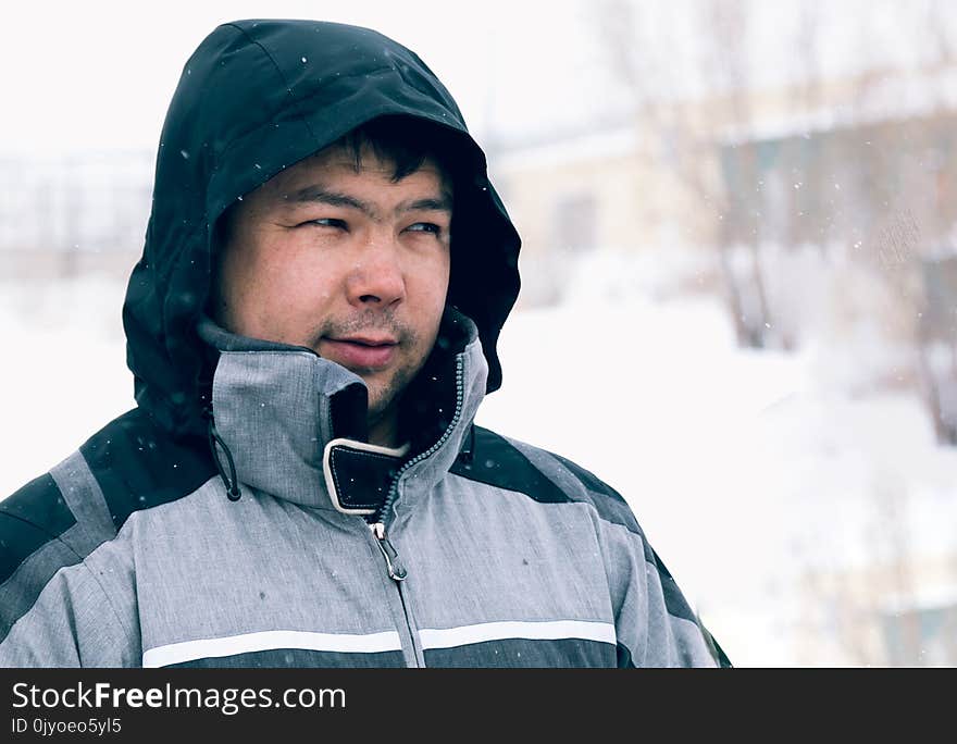 Portrait of a young man with a hood on his head