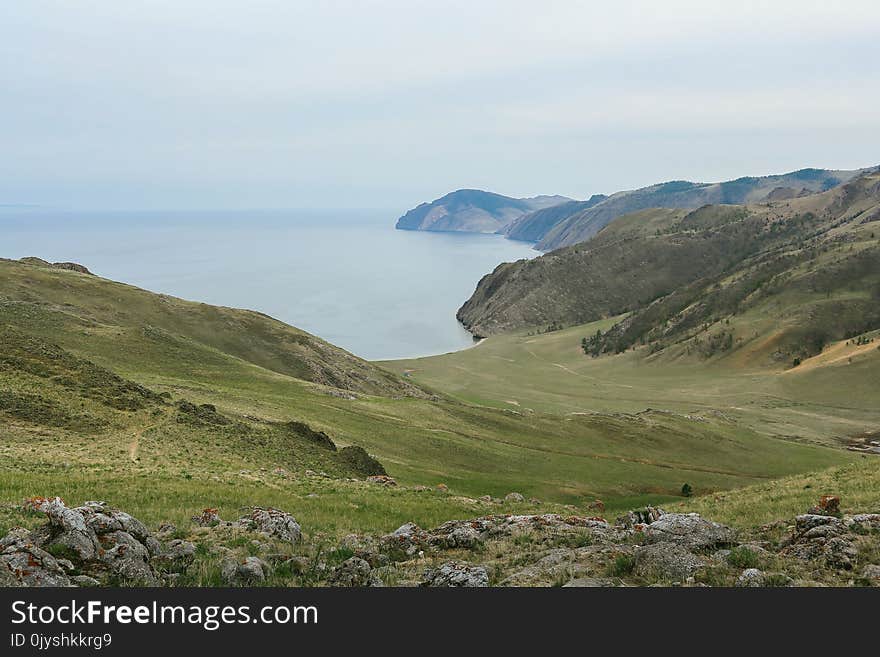 Lake Baikal, beautiful blue water and sky and green hills, Russia. Lake Baikal, beautiful blue water and sky and green hills, Russia.