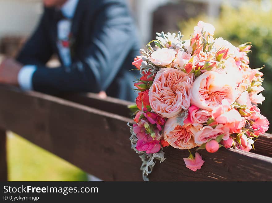 Bridegroom waiting his bride with the wedding bouquet