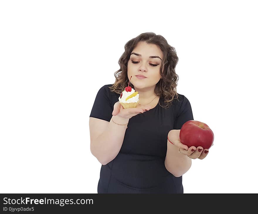 Full girl with a cake and an apple isolated dilemma