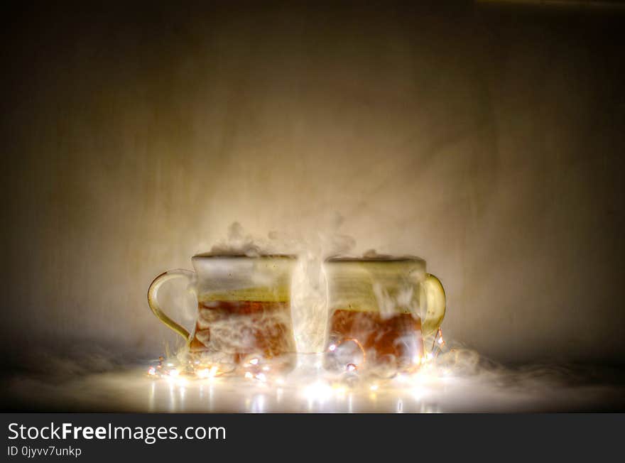 Two Red and Gold Mugs and Yellow String Lights