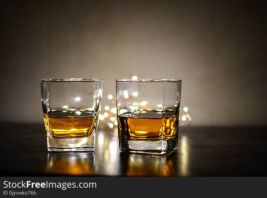 Two Clear Shot Glasses With Brandy