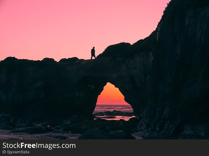 Silhouette of Man on Rock Walking during Nightime