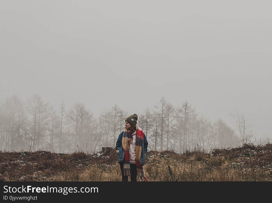 Person in Brown and Red Scarf