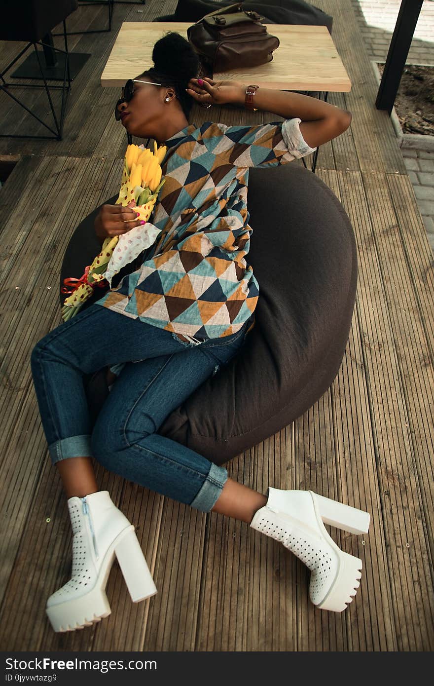 Woman Wearing Multicolored Dress Holding on Gray Bean Bag