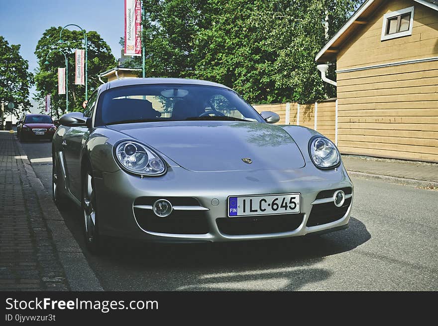 Silver Car Parked Near Wooden House