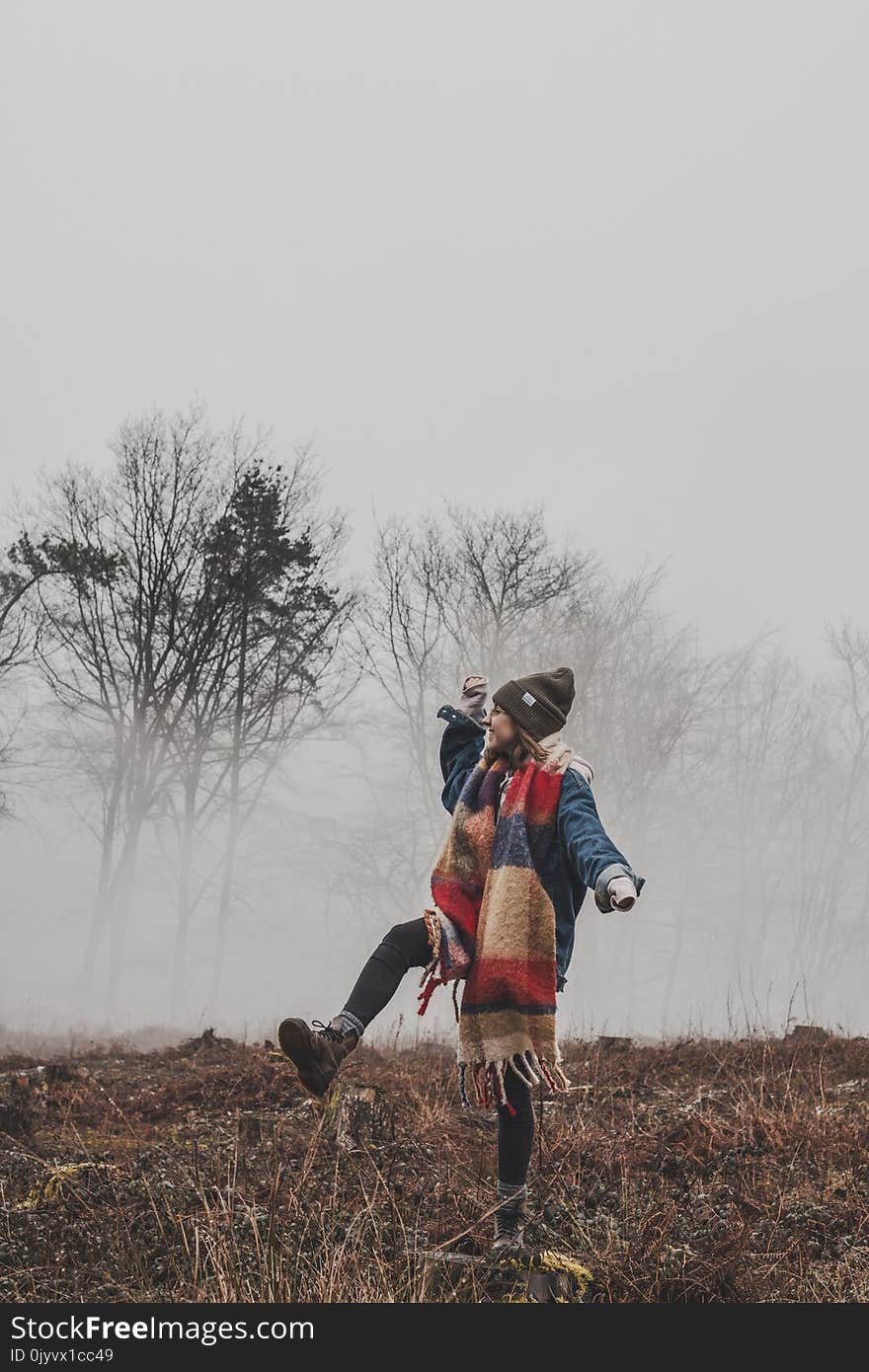 Woman Standing on a Grass Field