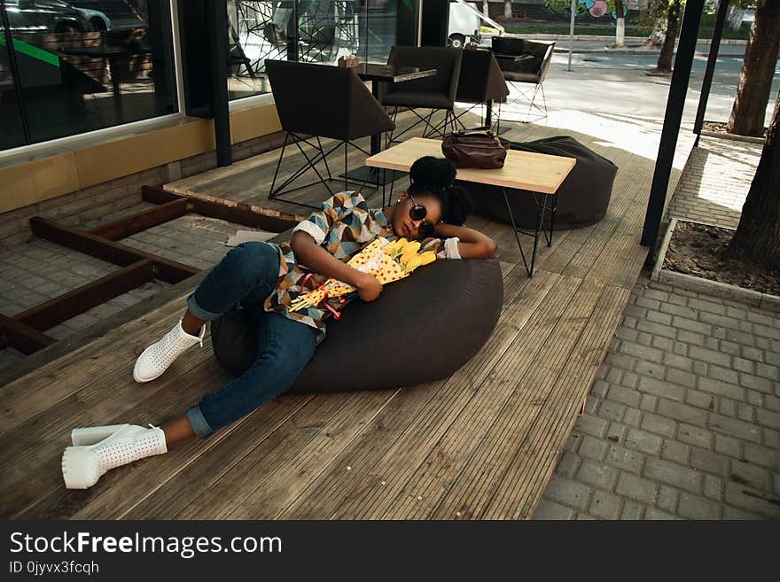 Person Lying on Bean Bag Chair