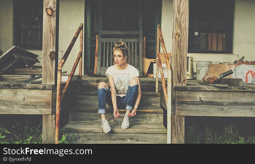 Woman Sitting on the Wooden Stair