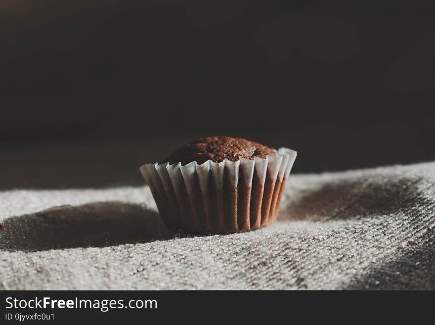 Still Life Photography of Muffin on White Textile