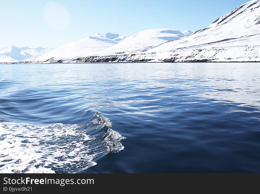 Photography of Calm Body of Water With Glacier Mountain