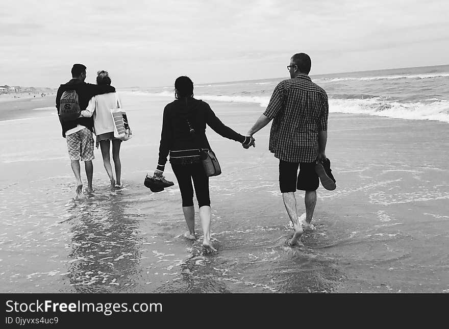 Gray Scale of Two Couples on the Beach