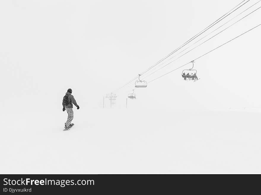 Man Walking in the Snow at Daytime