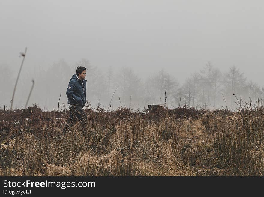 Man Walking on Grass Field