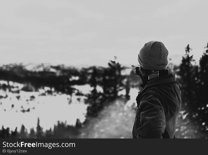 Person Wearing Jacket Pointing the Glacier Mountain