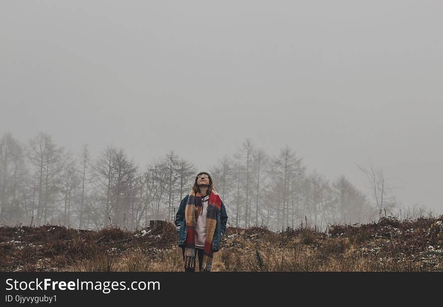 Person in Brown and Red Scarf