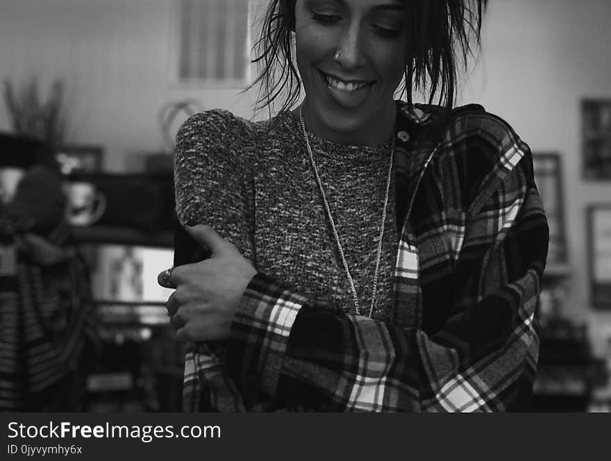 Gray Scale Photography of Woman Holding Her Arms