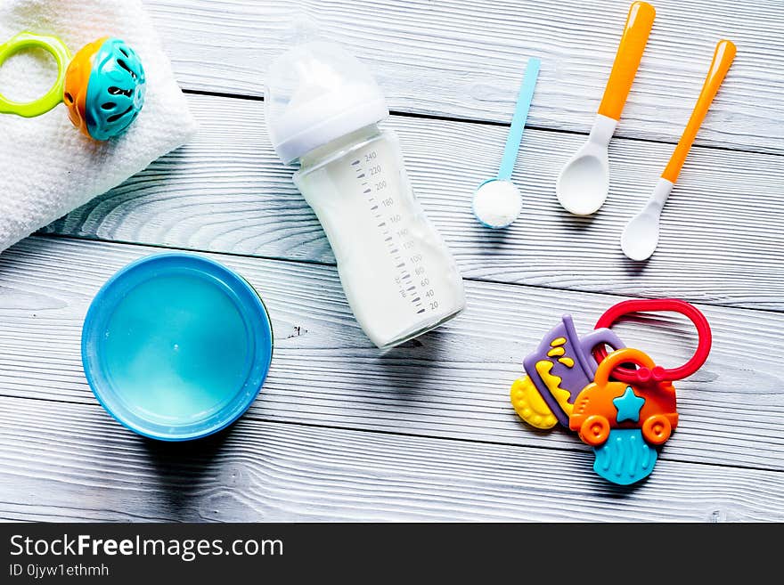 Preparation of mixture baby feeding on wooden background top view.