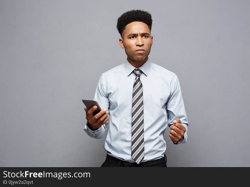 Business Concept - Stressful African American Businessman Shouting And Screaming On Mobile Phone.