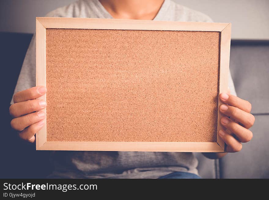 Your text here. Pretty young excited woman holding empty blank board.