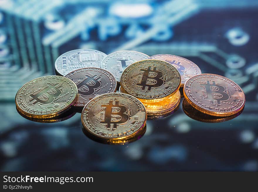 Mining Bitcoin gold, silver and copper coins and defocused print