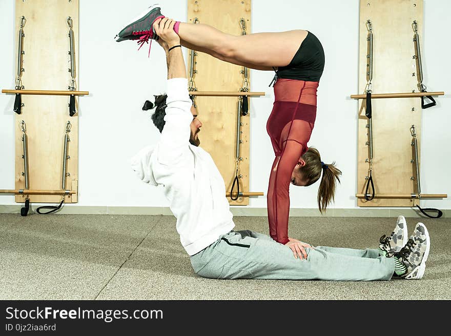 Young beautiful fitness couple workout extreme acrobatic exercise as preparation for the competition, selective focus