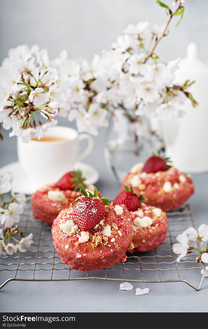 Strawberry shortcake donuts with fresh berries on a cooling rack. Strawberry shortcake donuts with fresh berries on a cooling rack