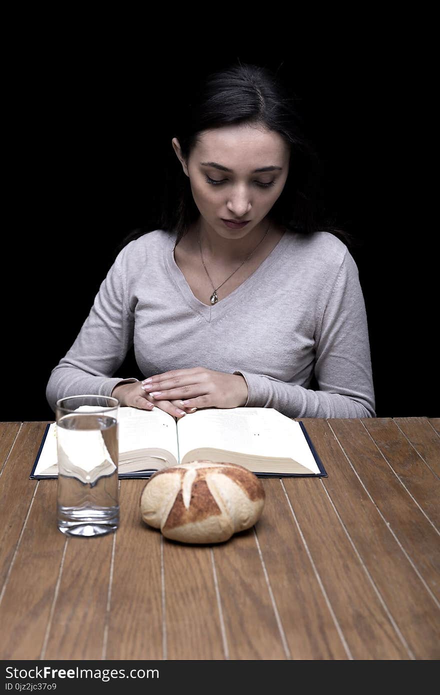 Young woman doing fasting and prayer in an interior