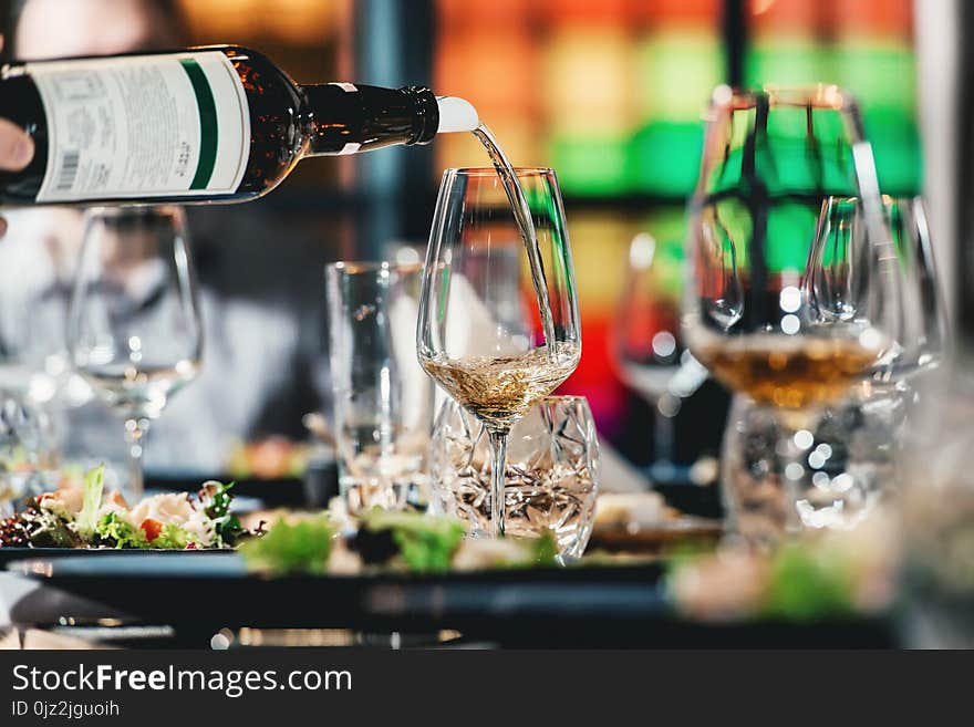 Served table at wine tasting. sommelier pouring wine from a bottle into glasses. Served table at wine tasting. sommelier pouring wine from a bottle into glasses