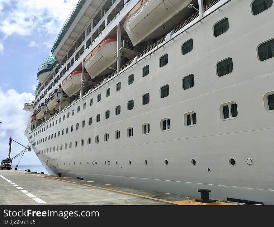 Large cruise ship without name docked in empty port. Large cruise ship without name docked in empty port