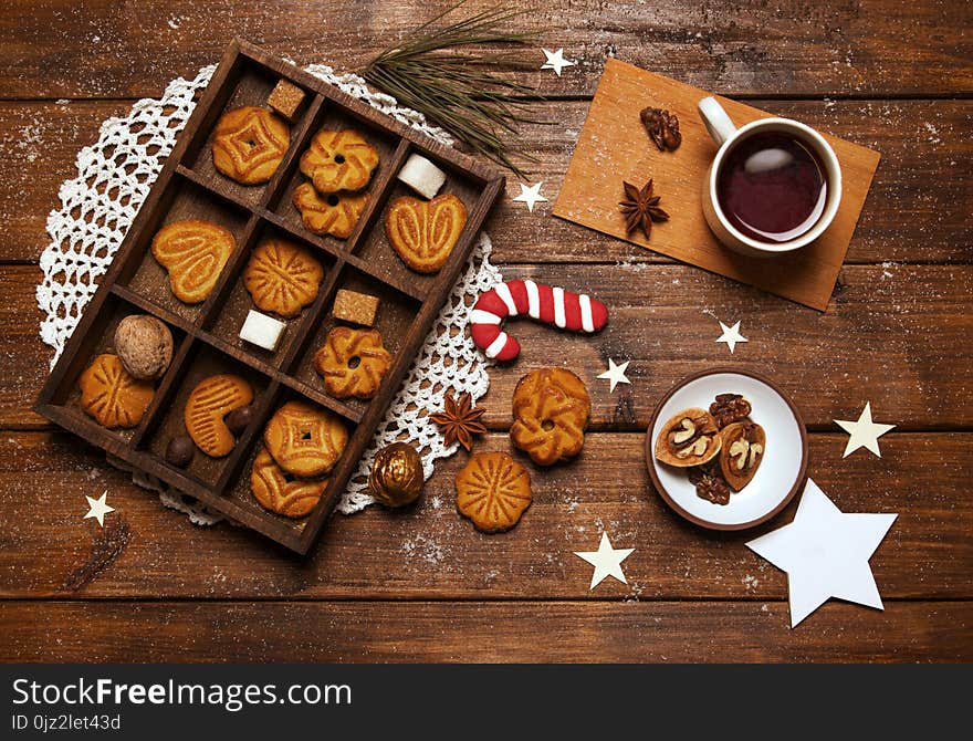 New Year`s day breakfast tea with nuts and sugar cane on wooden background